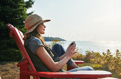 Buy stock photo Shot of an attractive young woman enjoying her day at the lake