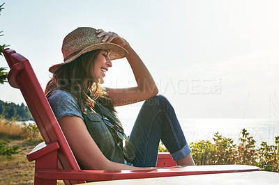 Buy stock photo Shot of an attractive young woman enjoying her day at the lake