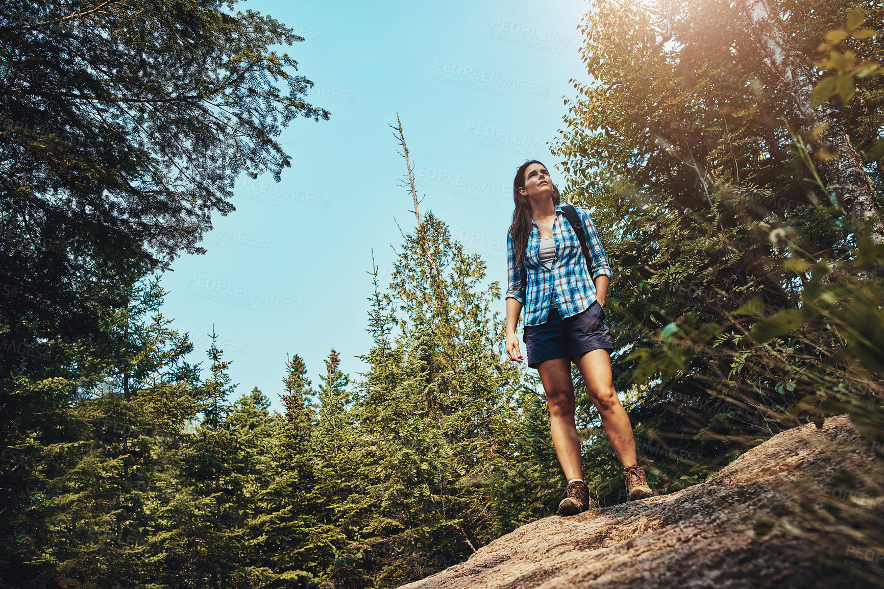 Buy stock photo Shot of a young woman going for a hike through nature