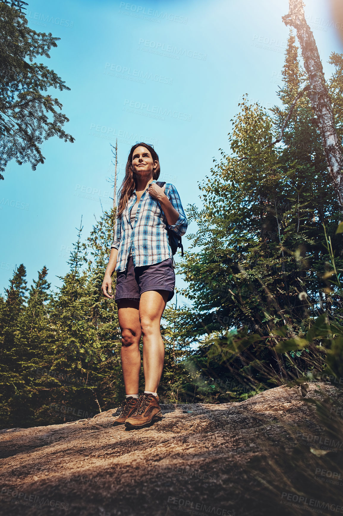 Buy stock photo Shot of a young woman going for a hike through nature