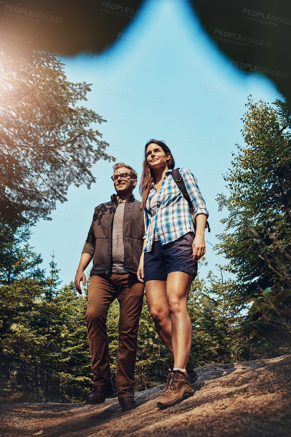Buy stock photo Shot of a young couple going for a hike through nature