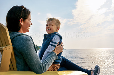 Buy stock photo Shot of a beautiful young mother and her son enjoying a day at the lake