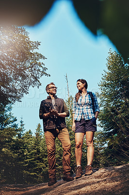 Buy stock photo Shot of a young couple going for a hike through nature