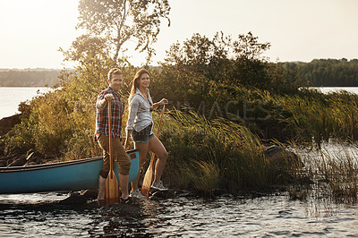 Buy stock photo Portrait of a young couple going for a canoe ride on the lake