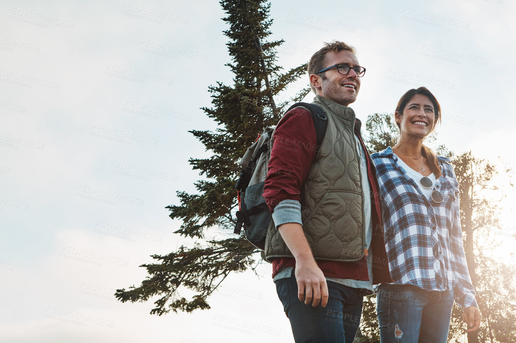 Buy stock photo Shot of a young couple exploring nature together