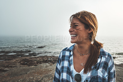 Buy stock photo Face, laughing and smile with woman on beach for holiday, travel or mental health day in nature. Funny, sky and water with happy person outdoor on coast at ocean or sea for thinking or wellness