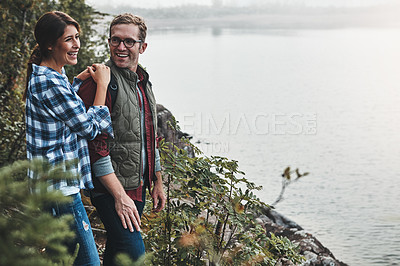 Buy stock photo Shot of a young couple exploring nature together