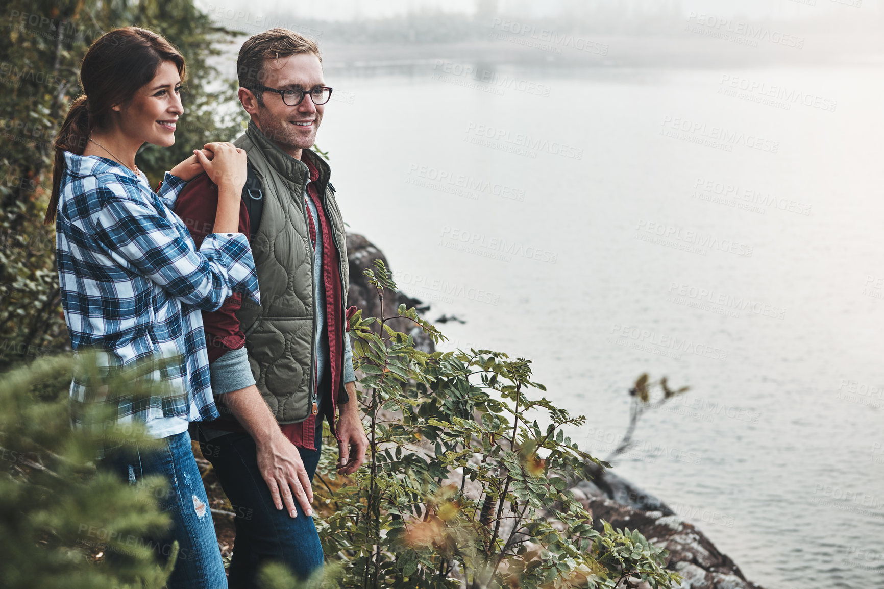 Buy stock photo Shot of a young couple exploring nature together