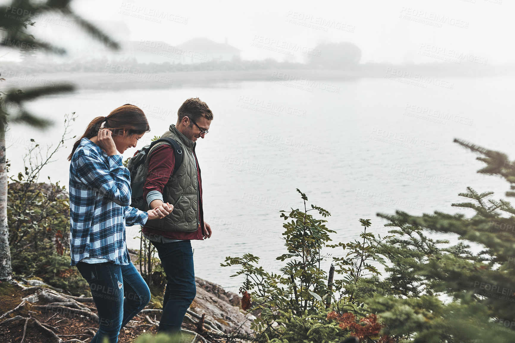 Buy stock photo Shot of a happy couple out hiking hand in hand