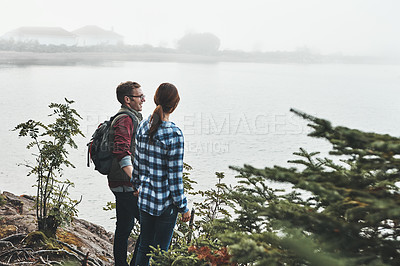 Buy stock photo Shot of a young couple exploring nature together