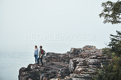 Buy stock photo Shot of a happy couple out hiking hand in hand