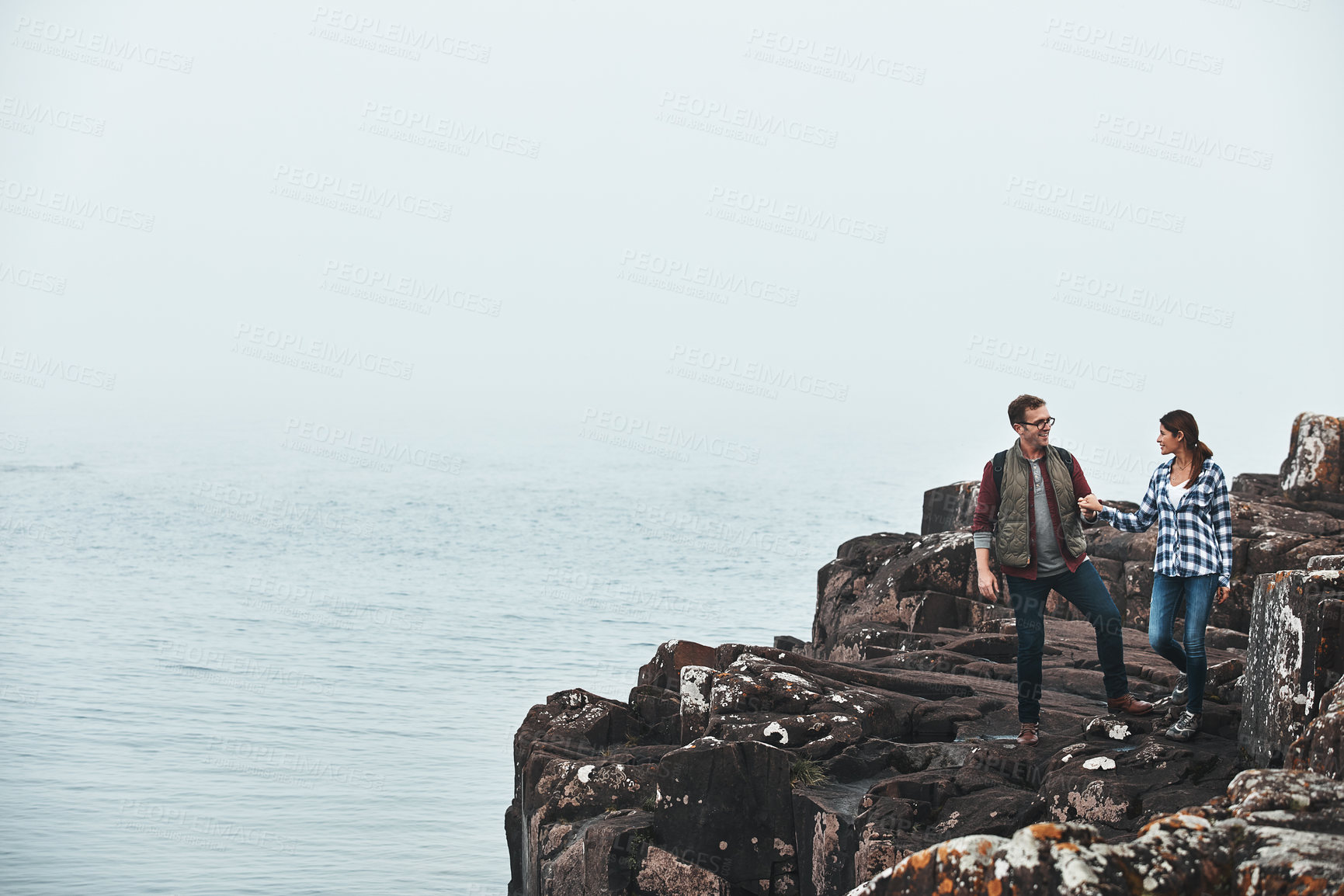 Buy stock photo Shot of a happy couple out hiking hand in hand