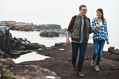 Buy stock photo Shot of a happy couple out hiking hand in hand