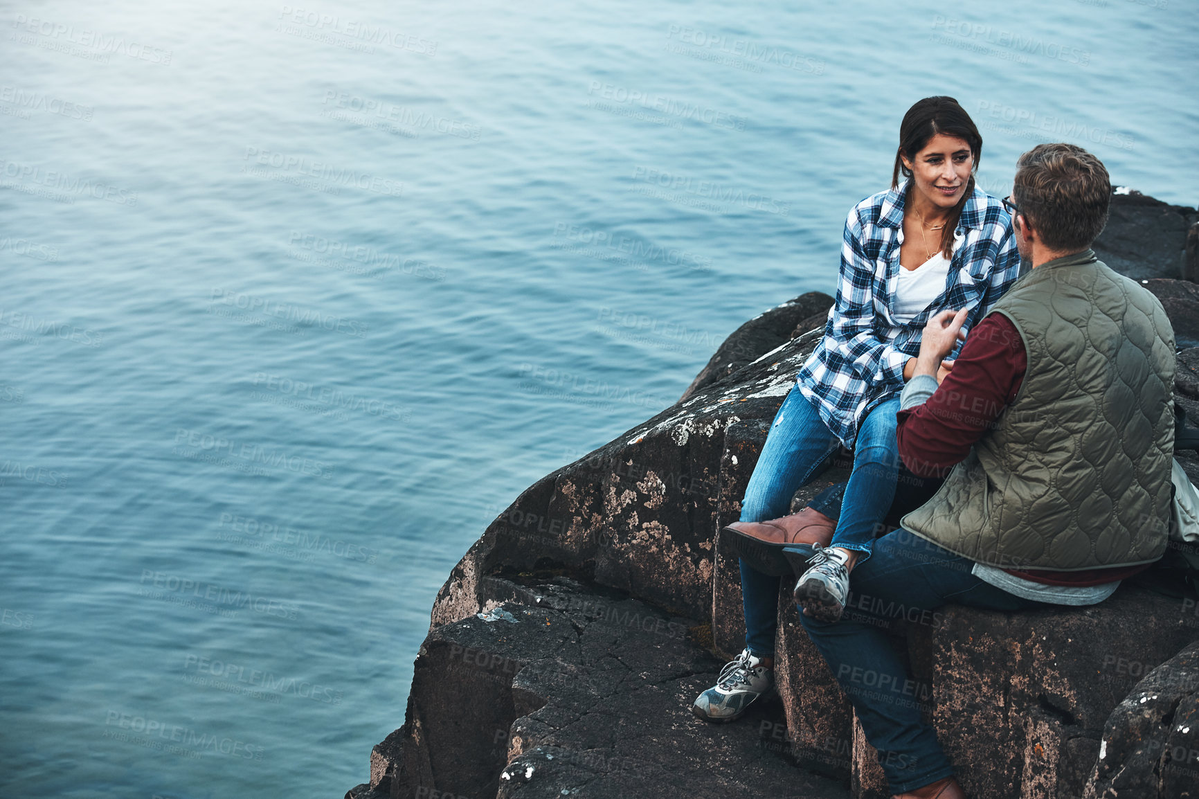 Buy stock photo Shot of a loving couple taking a break while out exploring nature