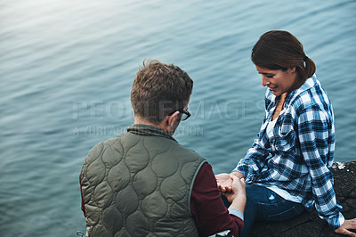 Buy stock photo Shot of a loving couple taking a break while out exploring nature