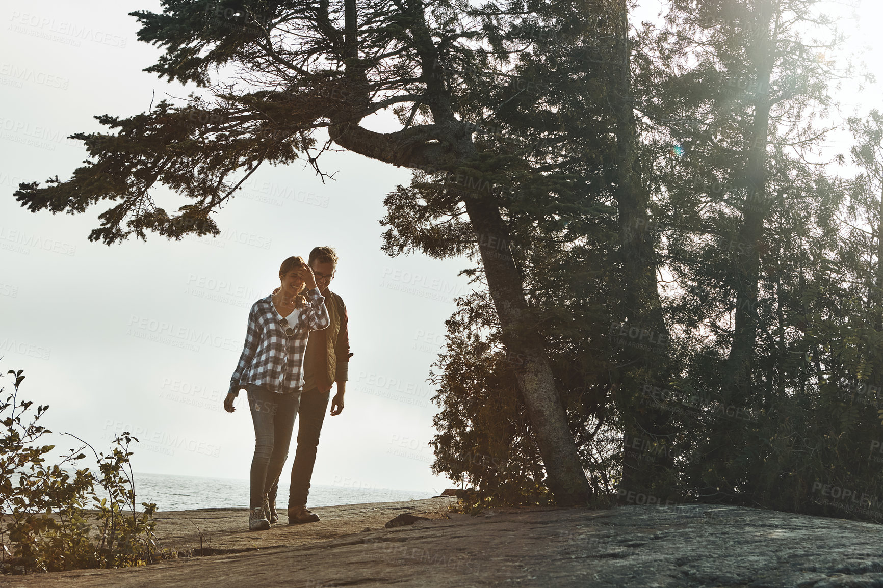 Buy stock photo Shot of a young couple out for a walk in nature
