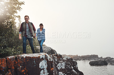 Buy stock photo Shot of a young couple out for a walk in nature