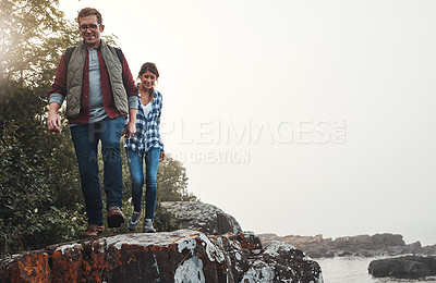 Buy stock photo Shot of a young couple out for a walk in nature