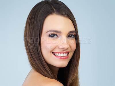 Buy stock photo Happy, beauty and portrait of woman with smile on blue background for wellness, skincare and spa treatment. Salon aesthetic, hair care and face of girl with cosmetics, makeup and facial in studio