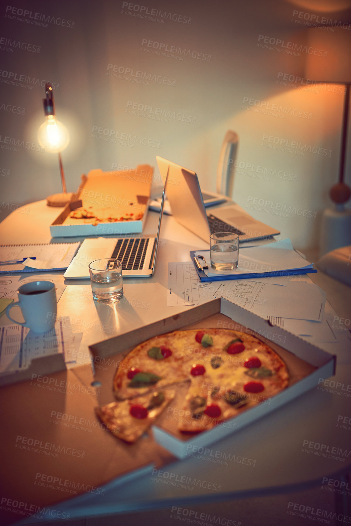 Buy stock photo Still life shot of pizza on a desk in an office