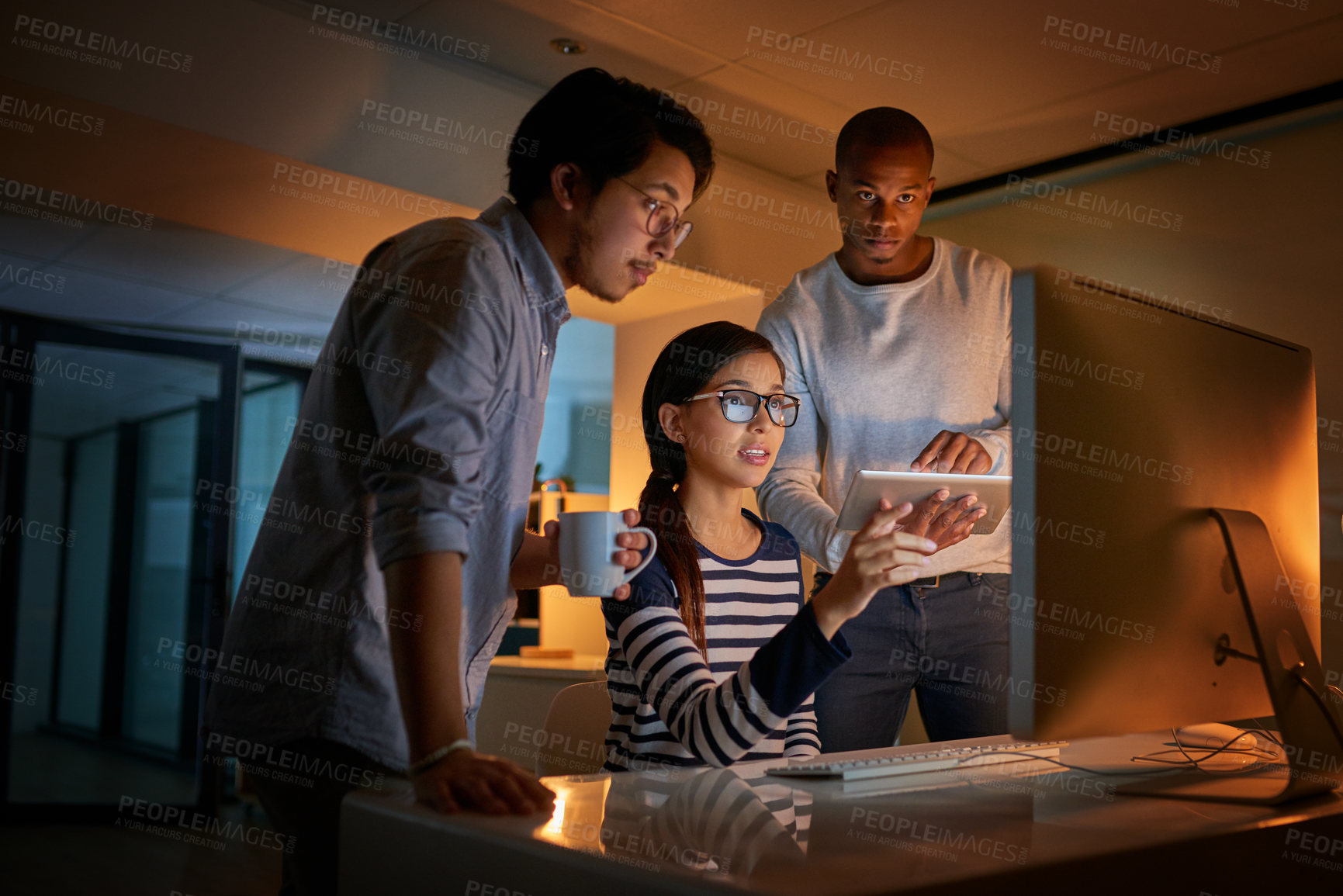 Buy stock photo Shot of computer programmers working together late in the office