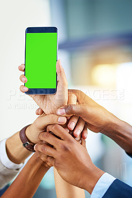 Buy stock photo Cropped shot of a group of businesspeople holding a mobile phone with a green screen in a modern office