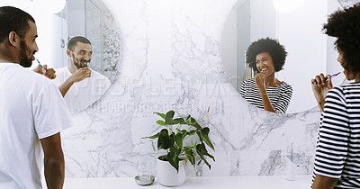 Buy stock photo Rearview shot of a cheerful young couple brushing their teeth in bathroom together at home