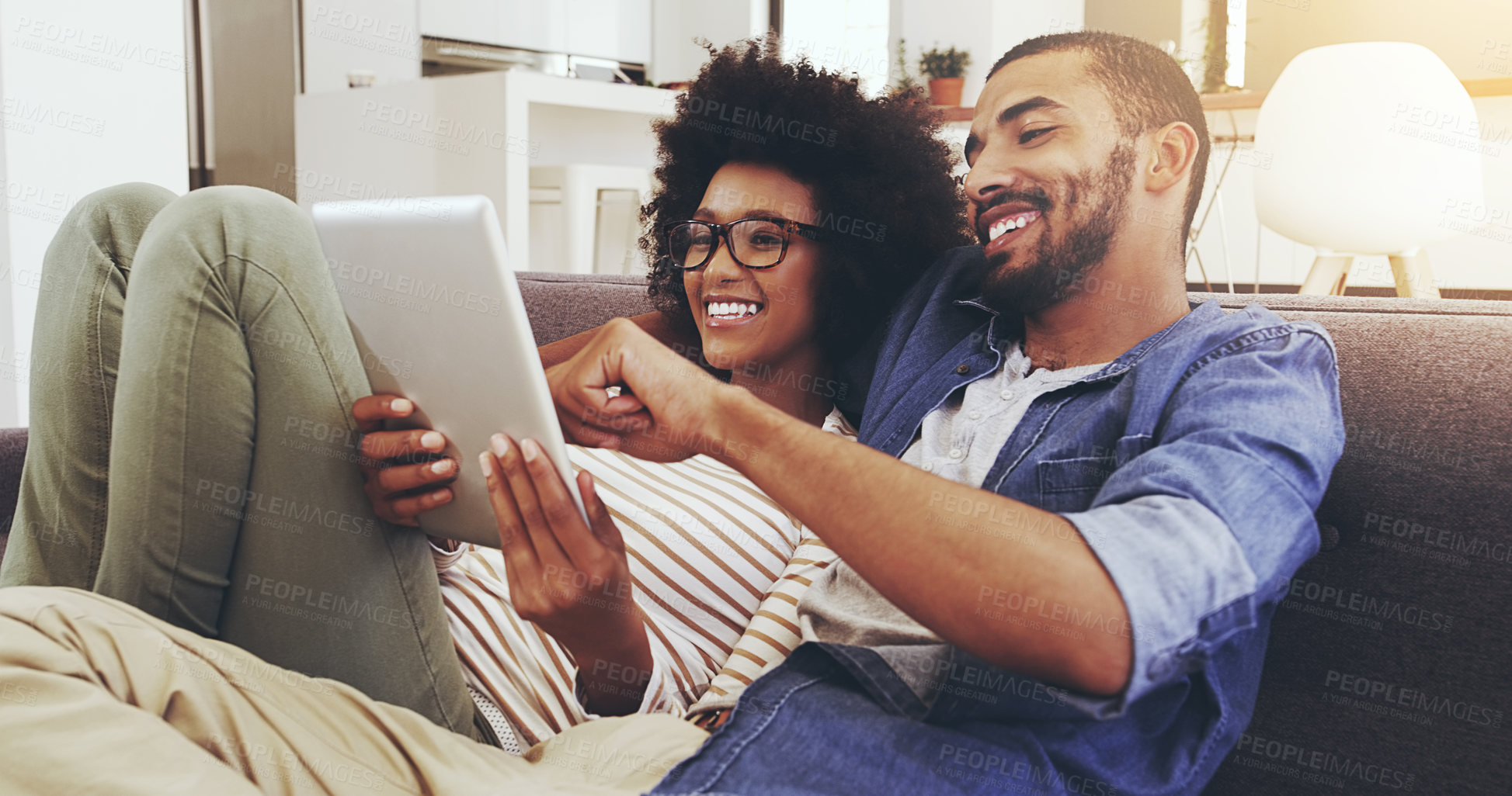 Buy stock photo Happy, home and couple on a couch, tablet and bonding with romance, typing and watching a film. Partners, man and woman on a sofa, technology and conversation with movie, network and internet search 