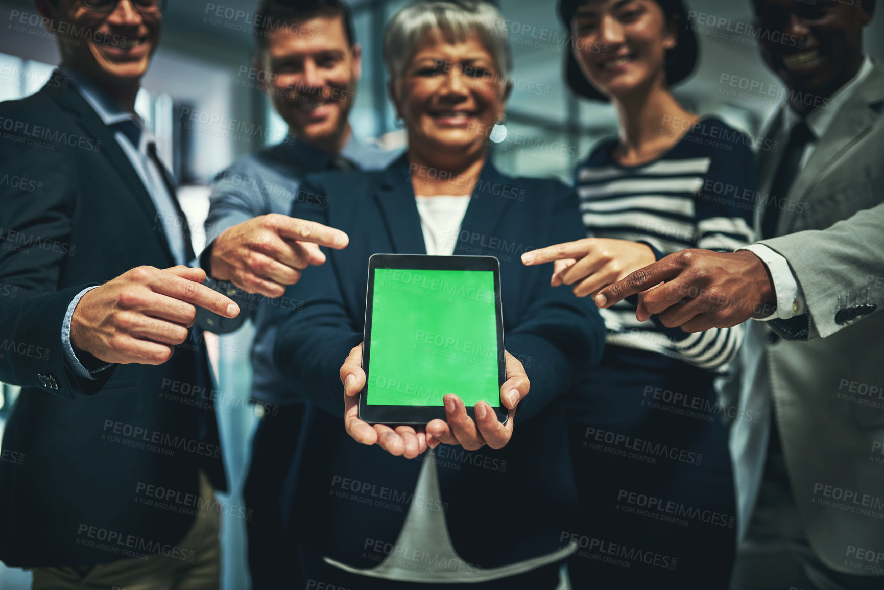Buy stock photo Shot of a group of businesspeople pointing to a digital tablet with a chroma key screen