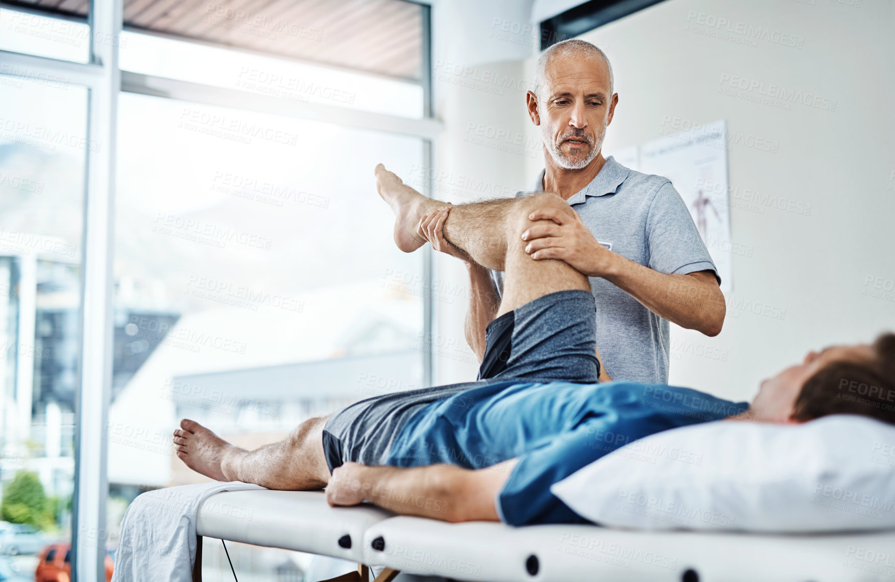 Buy stock photo Physical therapy, healing and patient with pain, leg and recovery with injury, accident and consultation. Male person, employee or chiropractor with customer, healthcare and physiotherapist with care
