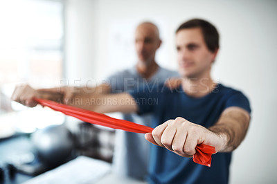 Buy stock photo Hands, resistance band for strength training and man with physiotherapist in office for stretching. Exercise, fitness and healthcare professional with physiotherapy patient in rehabilitation clinic