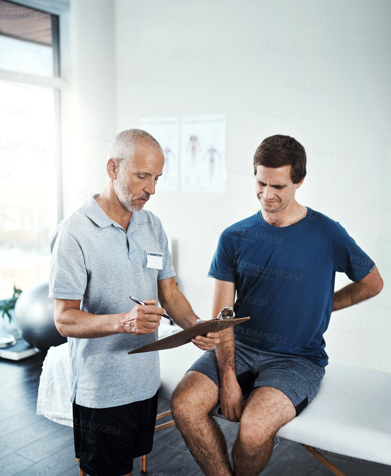 Buy stock photo Shot of a physiotherapist having a consultation with a patient