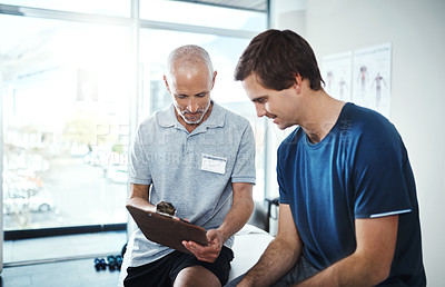 Buy stock photo Shot of a physiotherapist having a consultation with a patient