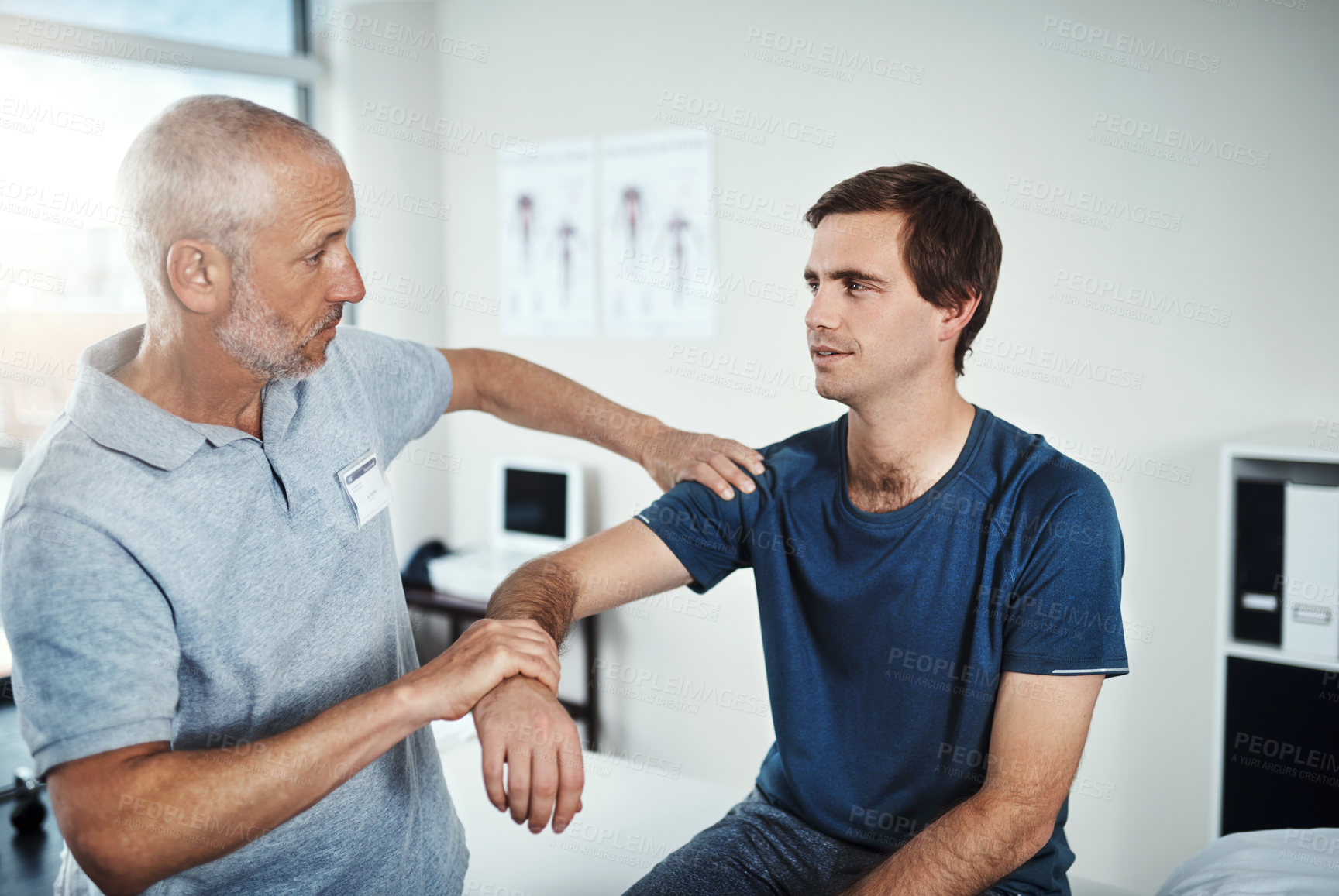 Buy stock photo Shot of a physiotherapist treating a patient 