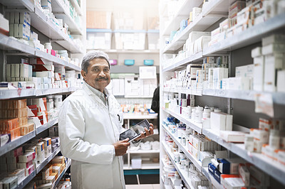 Buy stock photo Cropped portrait of a handsome mature male pharmacist working in a pharmacy