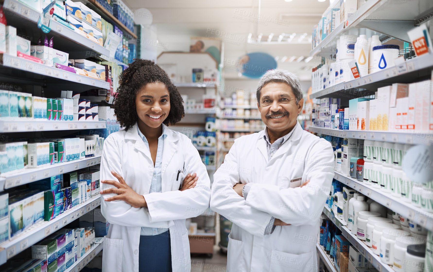 Buy stock photo Cropped portrait of two pharmacists standing together with their arms crossed in a pharmacy
