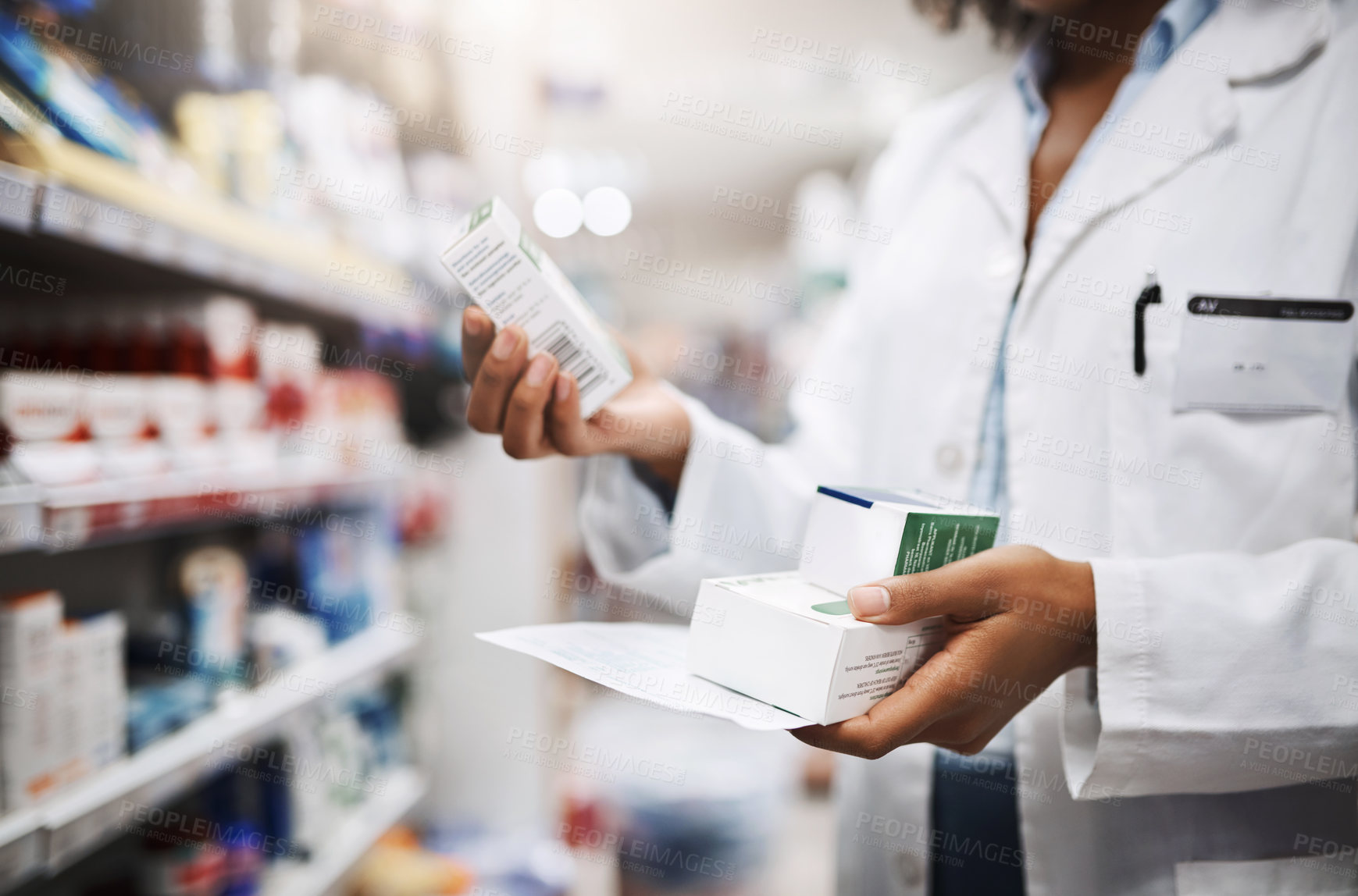 Buy stock photo Cropped shot of an unrecognizable young female pharmacist working in a pharmacy