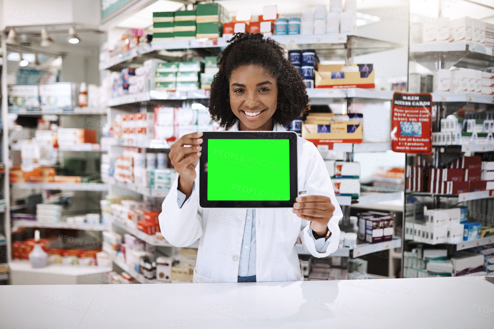 Buy stock photo Cropped portrait of an attractive young female pharmacist holding up a tablet with a chromakey screen