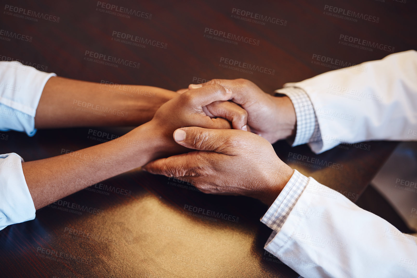 Buy stock photo Top view, doctor and holding hands of patient for comfort, healthcare or empathy for cancer diagnosis. Support, above and medical professional with sick person for kindness, help or trust in clinic