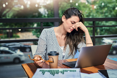 Buy stock photo Cropped shot of an attractive young businesswoman looking stressed while working on her laptop at a cafe