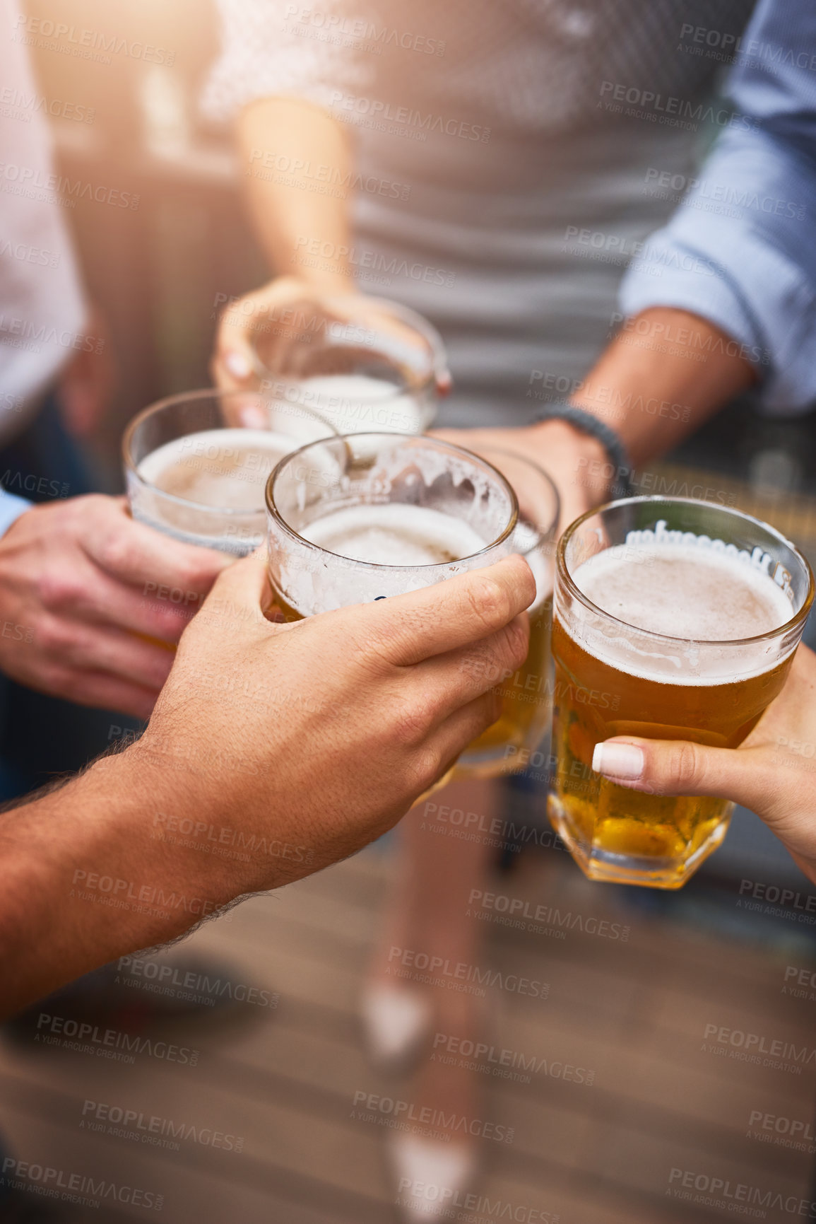 Buy stock photo Cropped shot of an unrecognizable group of businesspeople having drinks on their office balcony