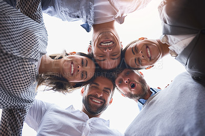 Buy stock photo Low angle shot of a group of businesspeople huddled together on their office balcony