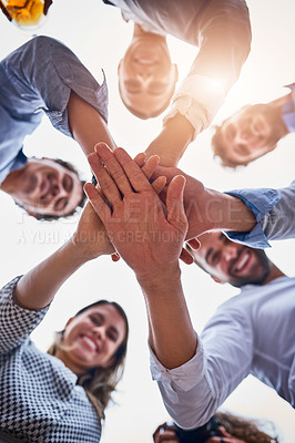 Buy stock photo Low angle shot of a group of businesspeople huddled together on their office balcony