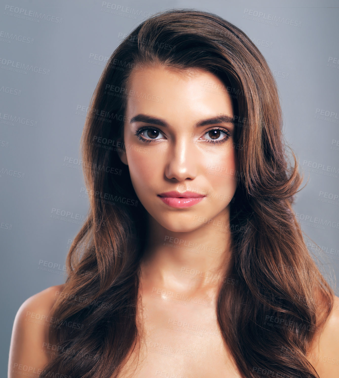 Buy stock photo Studio shot of a beautiful young woman posing against a gray background