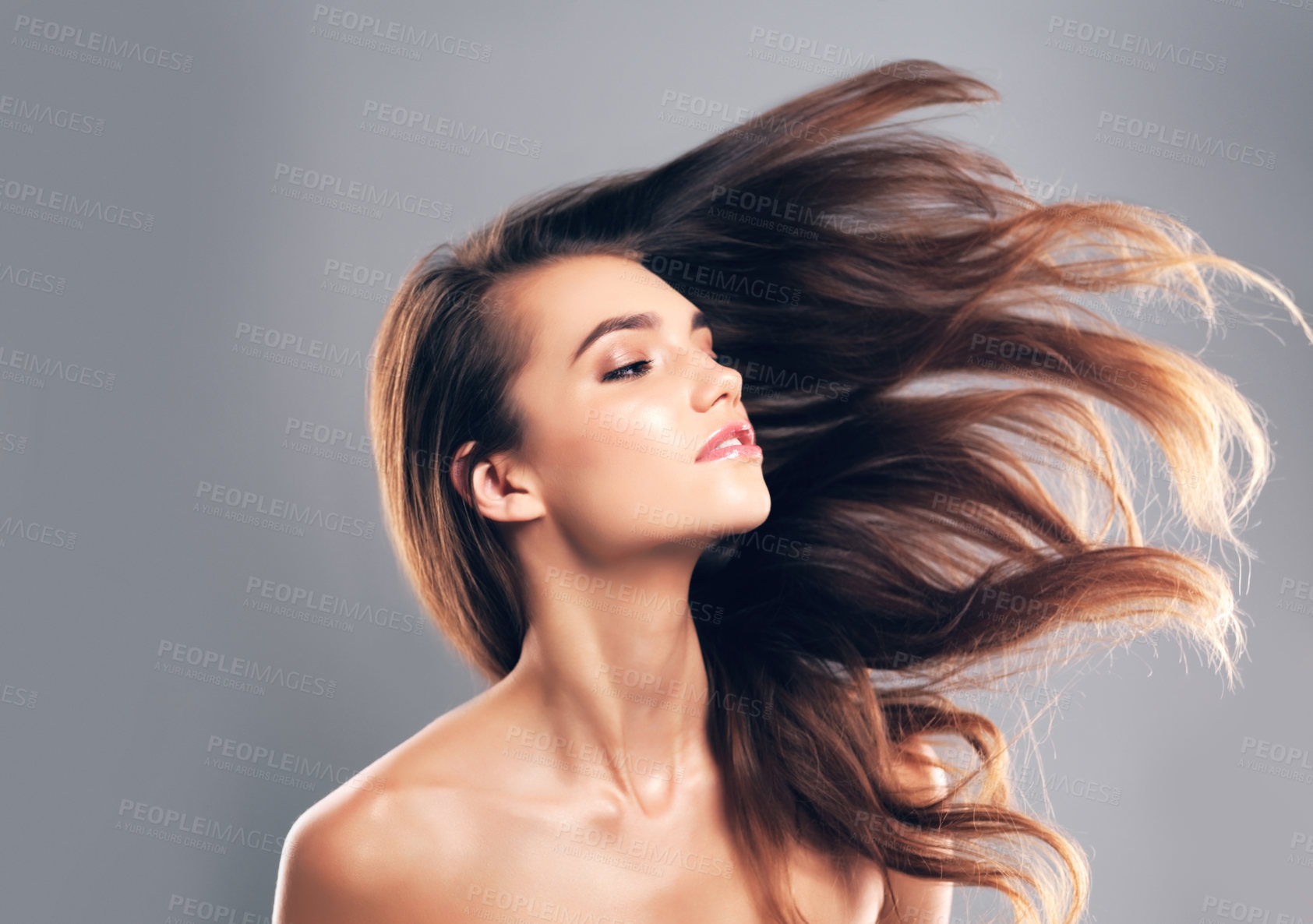 Buy stock photo Beauty, hairstyle and flip with woman in studio for glow, volume and hair gloss treatment. Scalp health, makeup and growth with person on gray background for haircare cosmetics, salon and keratin 