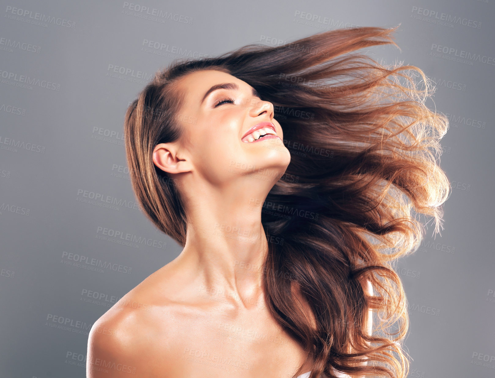 Buy stock photo Studio shot of a beautiful young woman posing against a gray background