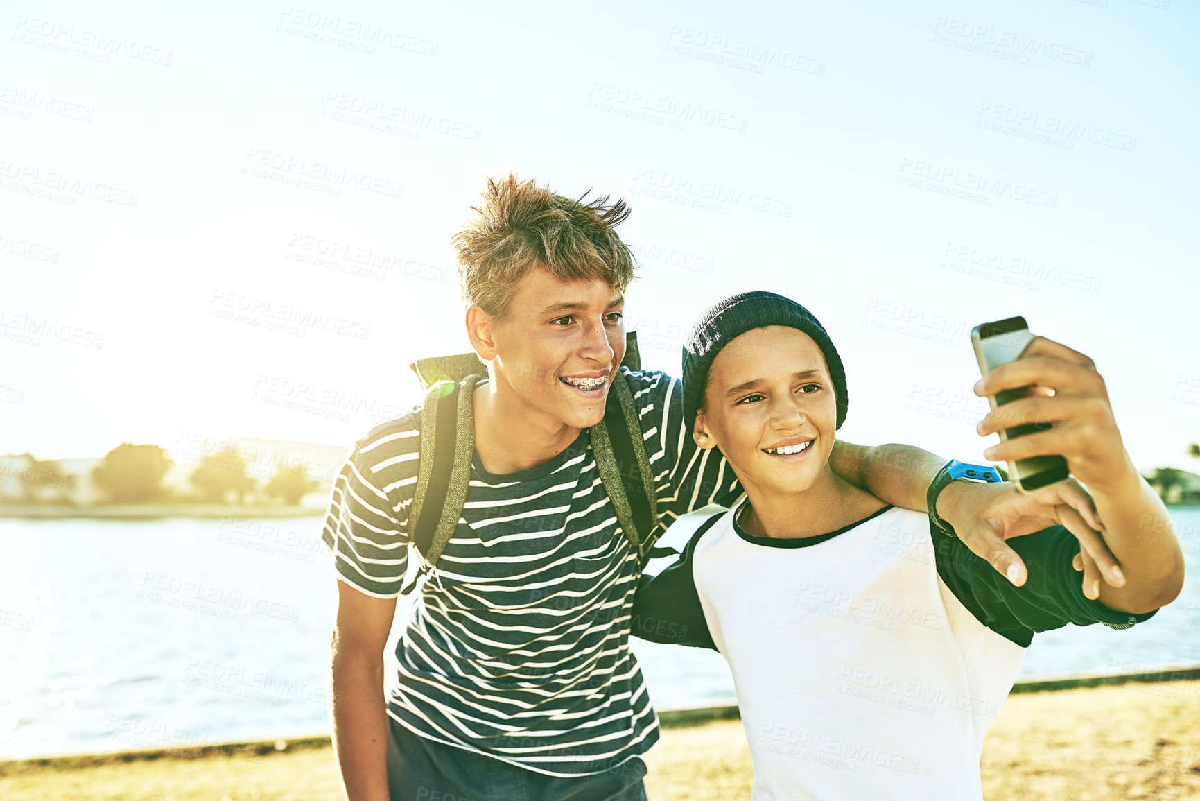 Buy stock photo Teenager, lake and outdoor with brother selfie on holiday and spring break with young boy by water. Nature, social media and lagoon with happy, smile and travel in Miami with trip post and update