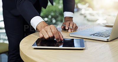 Buy stock photo Closeup shot of an unidentifiable businessman using a digital tablet and laptop in an office