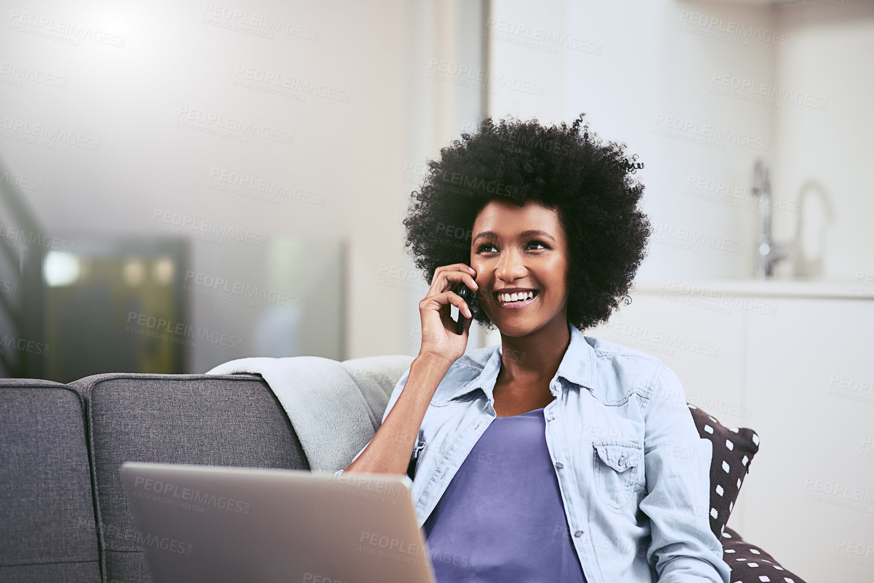 Buy stock photo African woman, laptop and phone call on sofa in house for conversation, networking and relax with smile. Tech, talk and remote work as social media manager for company, agency or business in lounge