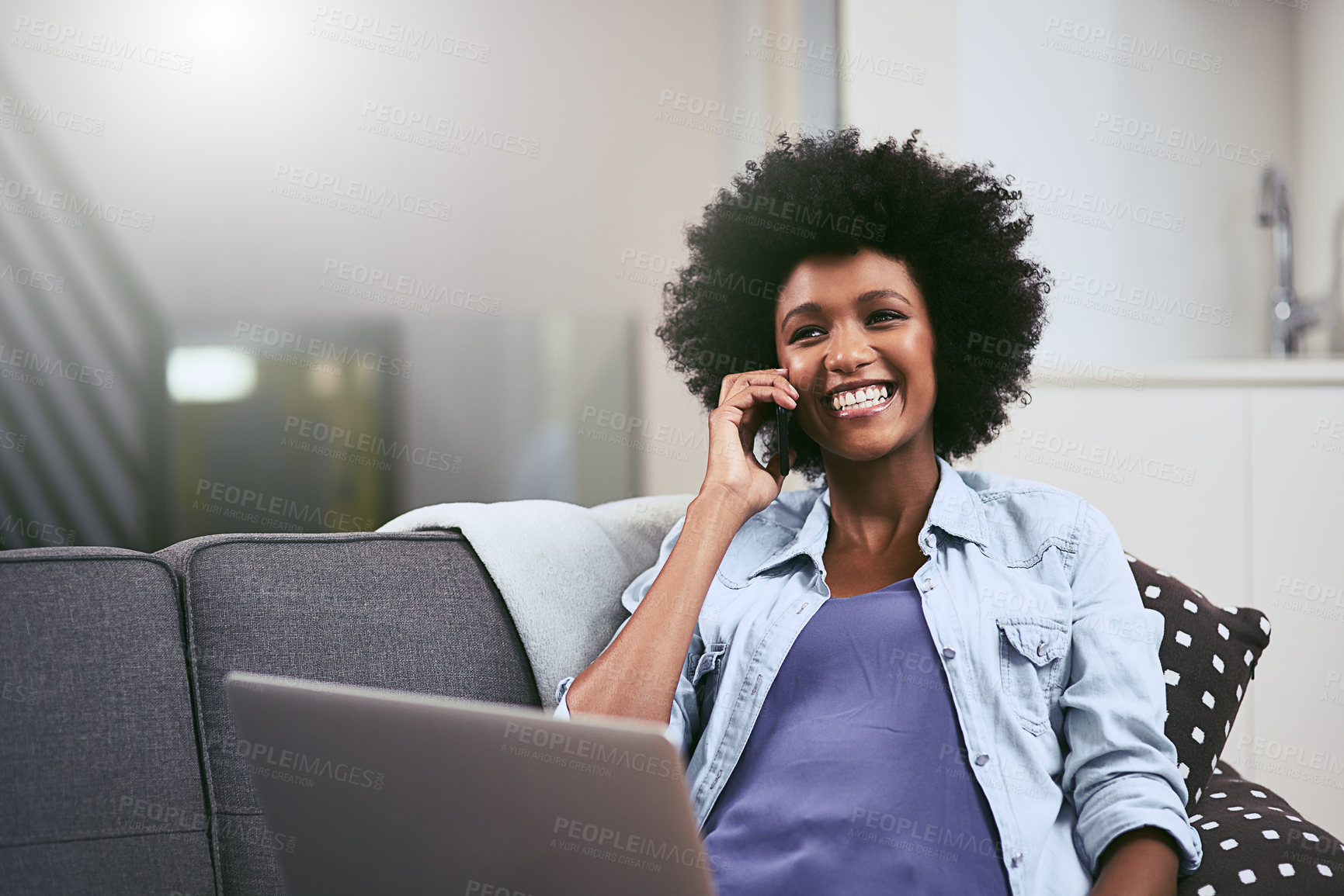 Buy stock photo African woman, smile and phone call on sofa in house for conversation, networking and relax with laptop. Tech, talk and remote work as social media manager for company, agency or business in lounge